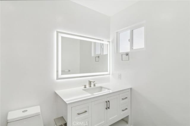 bathroom with toilet and vanity