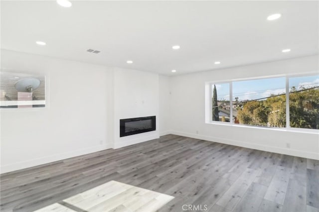 unfurnished living room with wood-type flooring