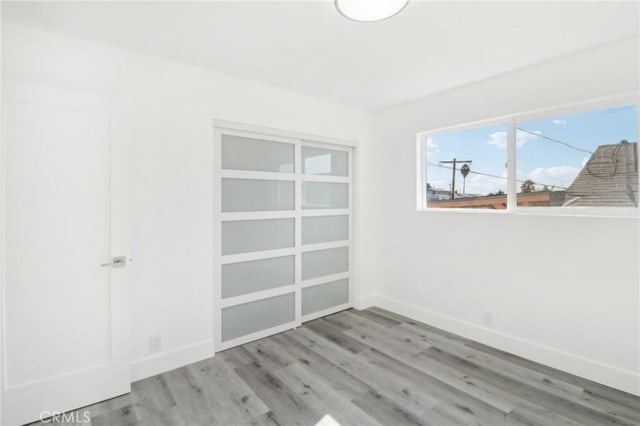 spare room with hardwood / wood-style floors