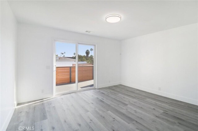 spare room with hardwood / wood-style flooring