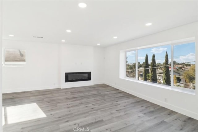 unfurnished living room with light hardwood / wood-style flooring