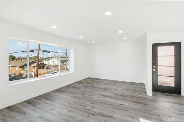 spare room with wood-type flooring