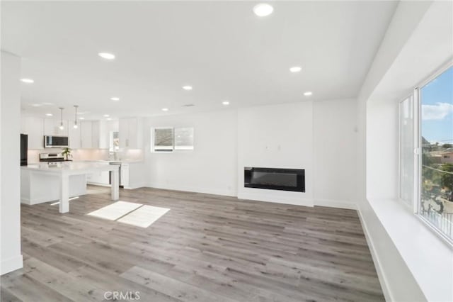 unfurnished living room featuring light hardwood / wood-style flooring