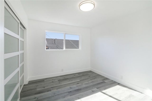 empty room with wood-type flooring