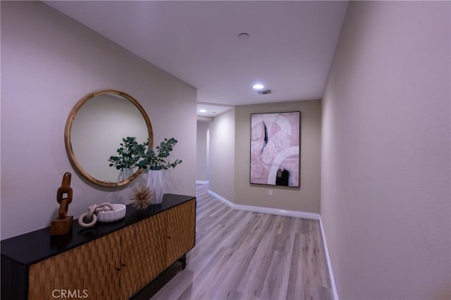 hallway with light hardwood / wood-style floors