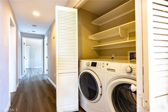 laundry room with dark hardwood / wood-style flooring and washer and dryer