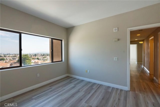 spare room with light hardwood / wood-style floors