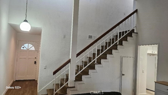 stairway featuring wood-type flooring