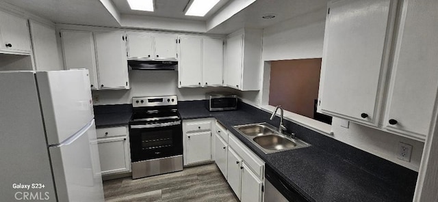 kitchen with hardwood / wood-style floors, sink, appliances with stainless steel finishes, and white cabinets