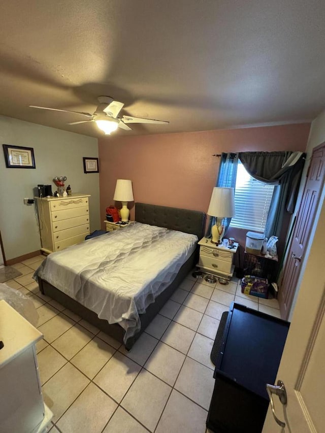 tiled bedroom with ceiling fan