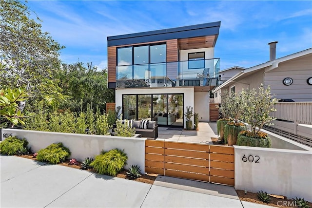 back of house featuring a balcony