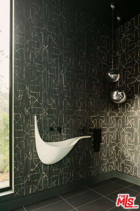 bathroom with tile walls and tile patterned flooring