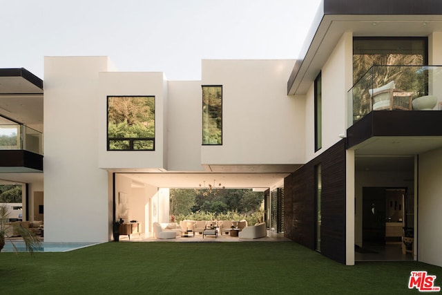 back of house with a lawn and a patio area