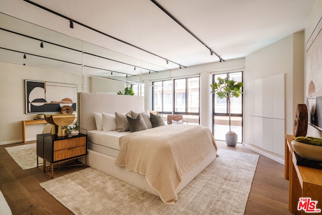 bedroom with dark hardwood / wood-style floors