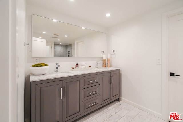 bathroom featuring vanity and a shower with shower door