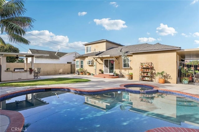 view of swimming pool with area for grilling, an in ground hot tub, and a patio area