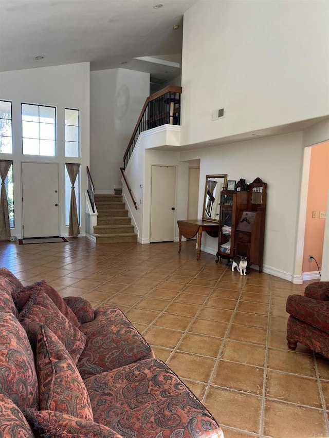 tiled living room with high vaulted ceiling