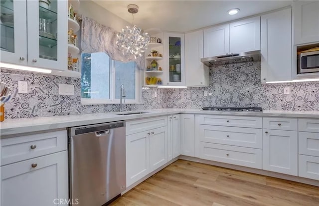 kitchen with sink, appliances with stainless steel finishes, light wood-type flooring, and white cabinets