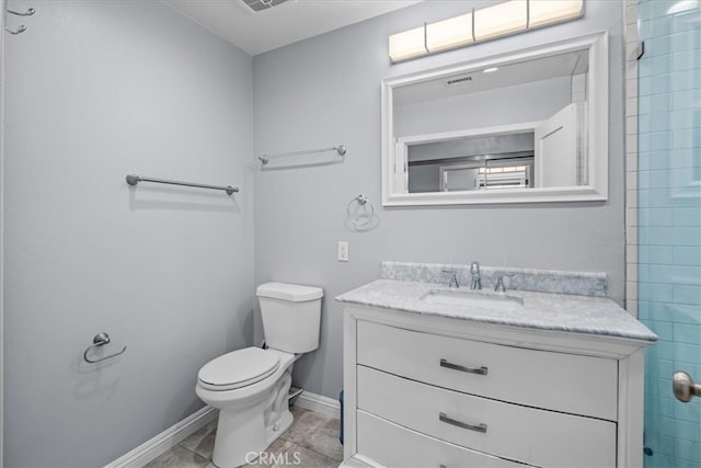 bathroom with vanity, toilet, and tile patterned floors