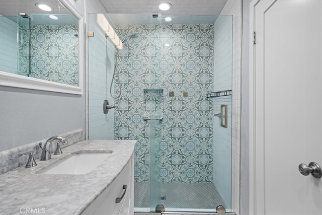 bathroom featuring vanity and a shower with shower door