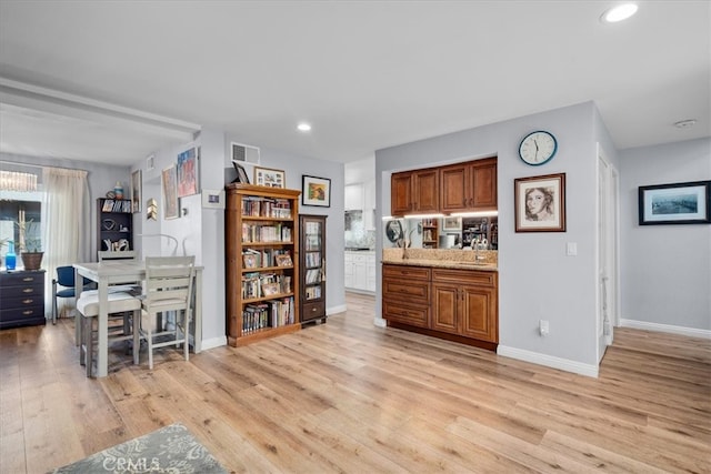 kitchen with light stone counters and light wood-type flooring