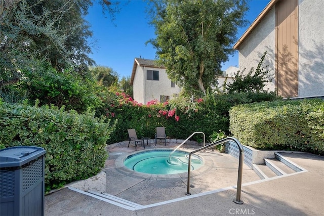 view of pool with a patio, central AC, and an in ground hot tub