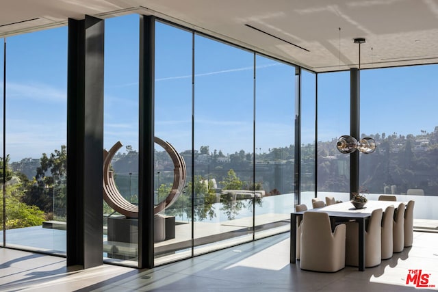 interior space with a water view and expansive windows