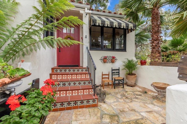 property entrance with a patio