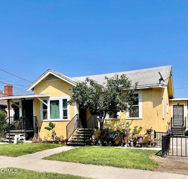 bungalow-style house featuring a front lawn