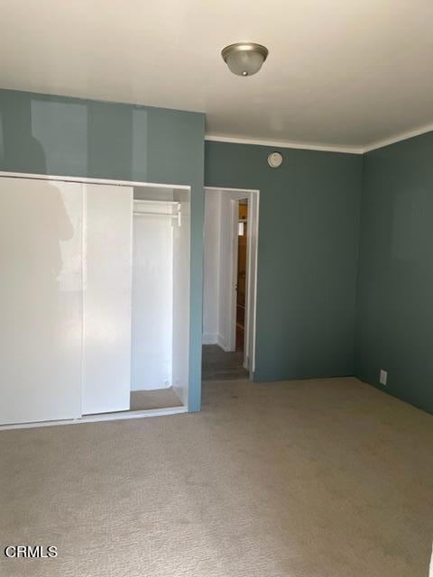 unfurnished bedroom featuring a closet and carpet floors