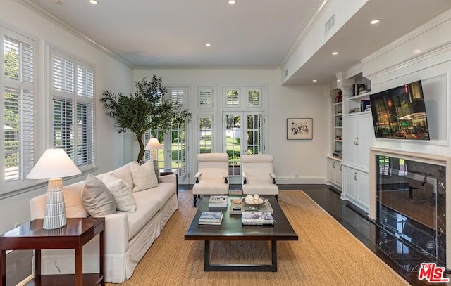 living room featuring a healthy amount of sunlight, ornamental molding, and dark hardwood / wood-style flooring