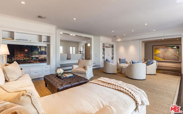 living room with crown molding and wood-type flooring