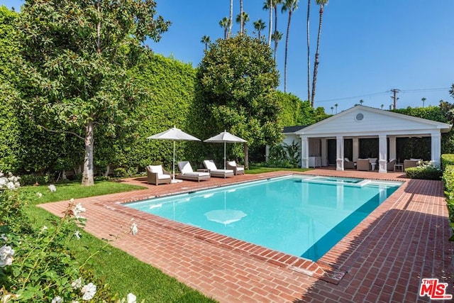 view of pool with a patio and an outdoor living space