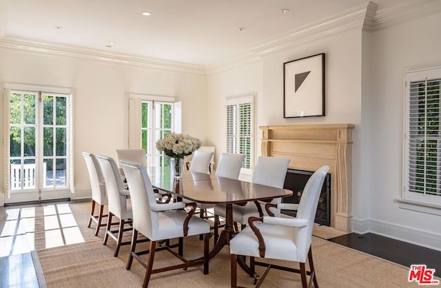 dining space featuring crown molding and hardwood / wood-style flooring