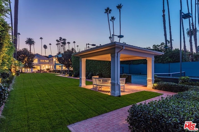 yard at dusk with a patio and a gazebo