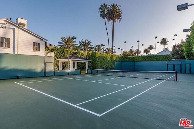 view of tennis court with a gazebo