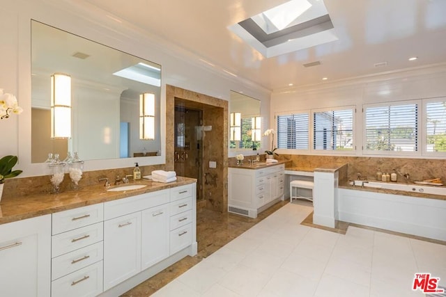 bathroom with tile patterned flooring, ornamental molding, vanity, shower with separate bathtub, and a skylight