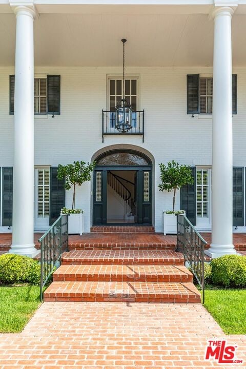 view of exterior entry with covered porch