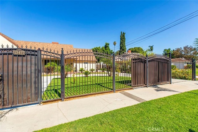 view of gate featuring a yard