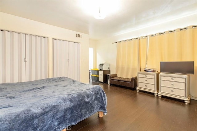 bedroom with dark hardwood / wood-style floors