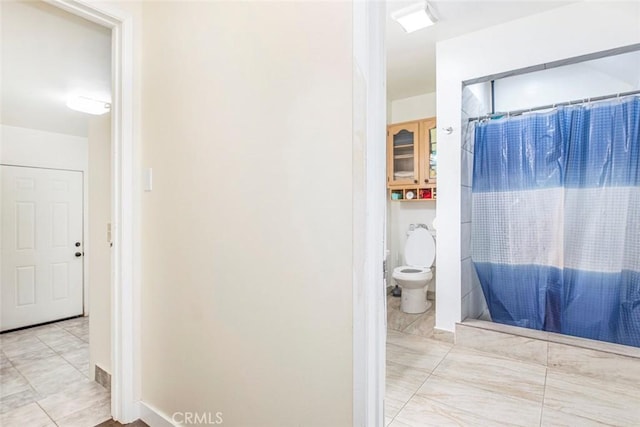 bathroom with toilet and walk in shower