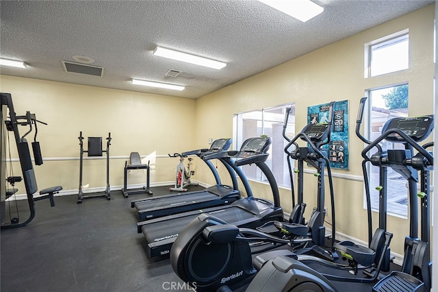 exercise room featuring a textured ceiling