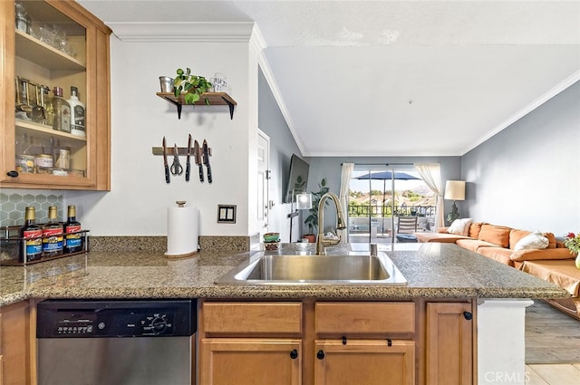 kitchen featuring kitchen peninsula, stainless steel dishwasher, light wood-type flooring, ornamental molding, and sink