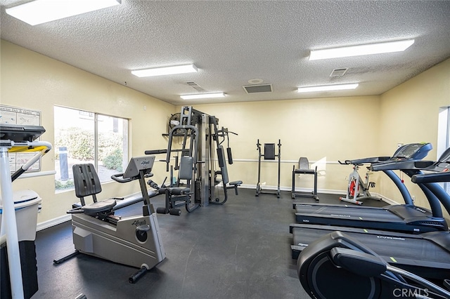 gym featuring a textured ceiling