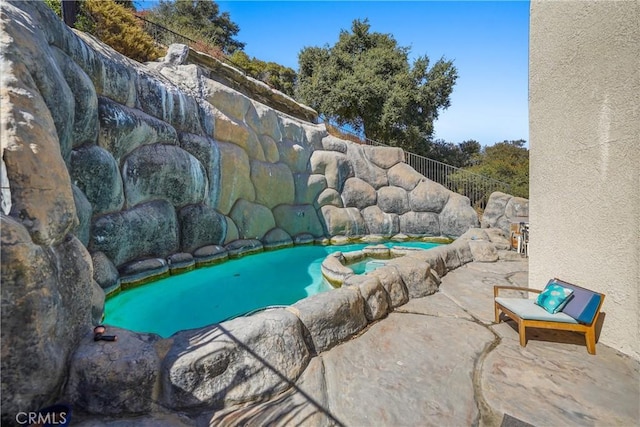 view of pool with an in ground hot tub