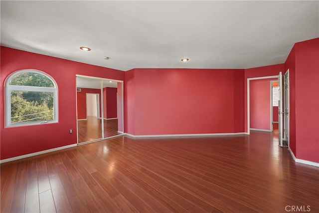 empty room with dark hardwood / wood-style floors