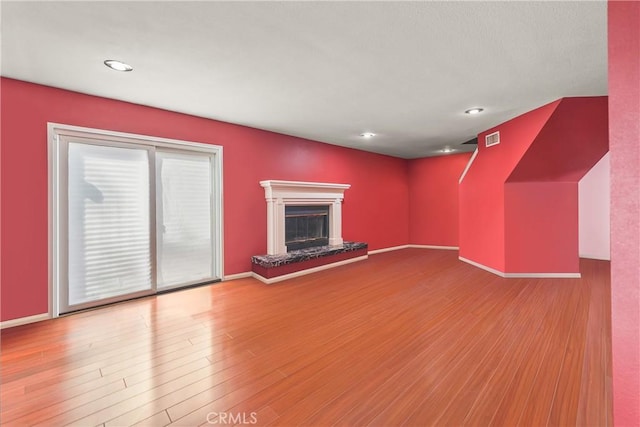 unfurnished living room with wood-type flooring