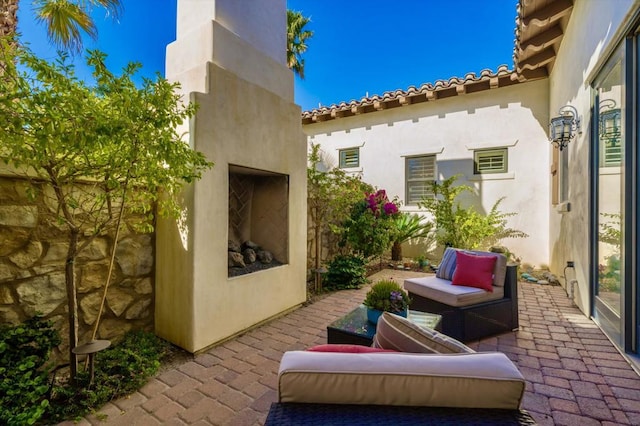 view of patio with an outdoor fireplace