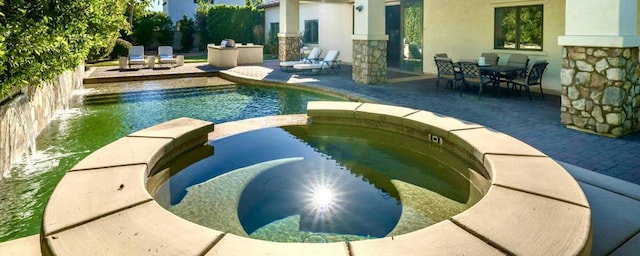 view of swimming pool with a patio area and an in ground hot tub