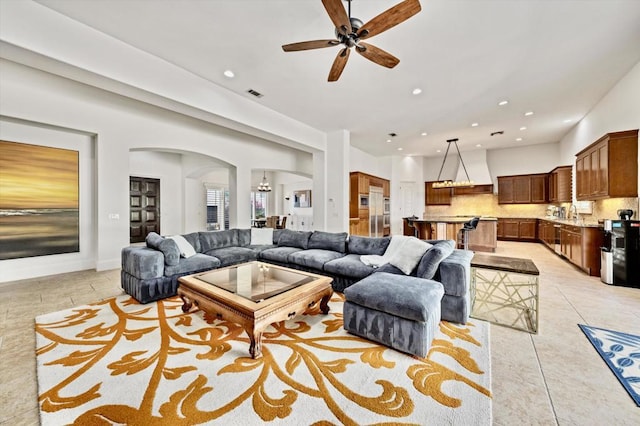 living room with ceiling fan and light tile patterned flooring